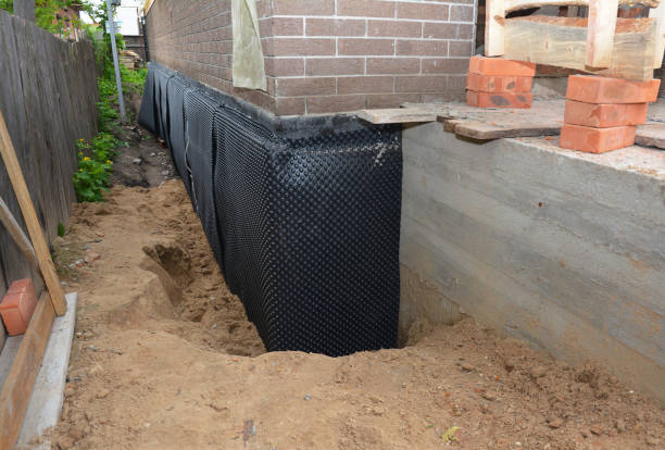 SJ Waterproofing Pros technician performing targeted Interior Drainage System assessment in Okemos, MI